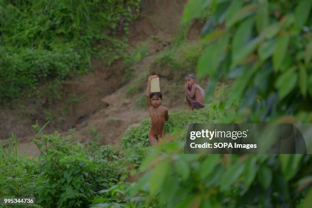 Reang kids seen naked at a narrow stream. 35,000 people of Reang also called Bru in Kanchanpur refugee camp, fled here due to severe ethnic clashes...