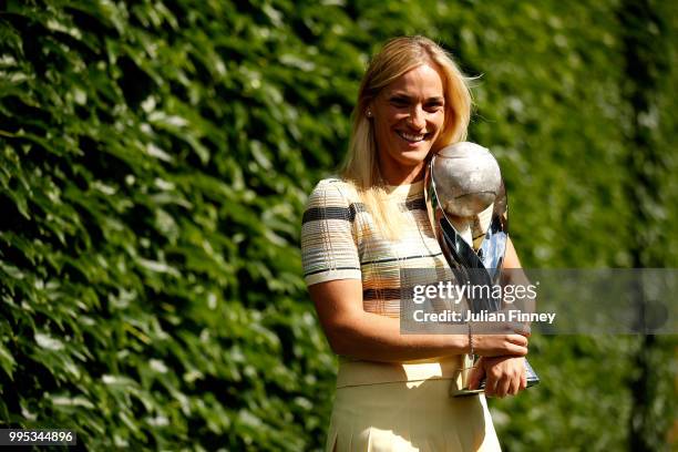 Timea Babos of Hungary poses with the WTA World No.1 Doubles trophy on day eight of the Wimbledon Lawn Tennis Championships at All England Lawn...