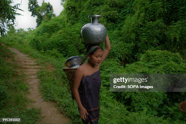 Reang girl seen carrying a pot of water. 35,000 people of Reang also called Bru in Kanchanpur refugee camp, fled here due to severe ethnic clashes...