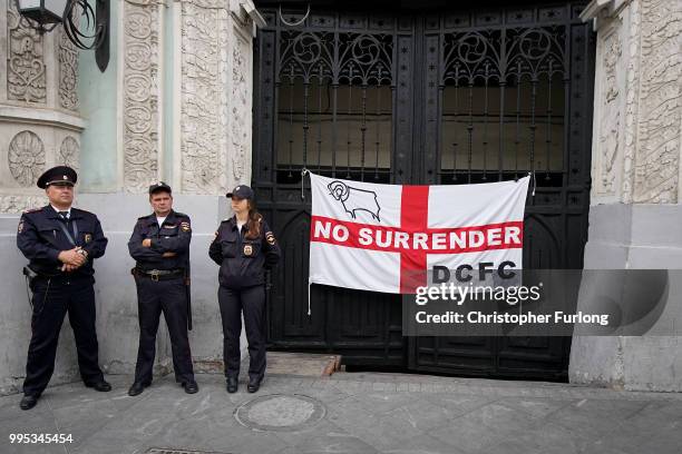 Police officers keep a watchful eye in Nikolskaya St near Red Square as England fans arrive ahead of the World Cup semi-final game between England...