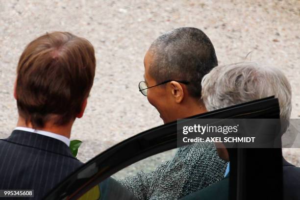 Liu Xia , the widow of Chinese Nobel Peace Prize laureate Liu Xiaobo, gets in to a car after she arrives at Tegel Airport in Berlin on July 10, 2018....