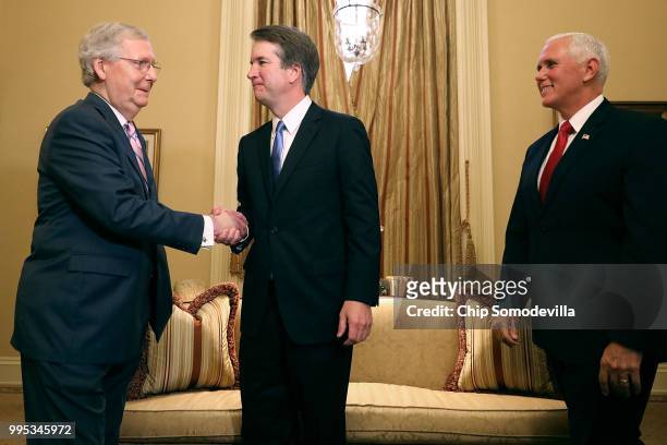 Senate Majority Leader Mitch McConnell shakes hands with Judge Brett Kavanaugh as he arrives with Vice President Mike Pence before a meeting in...
