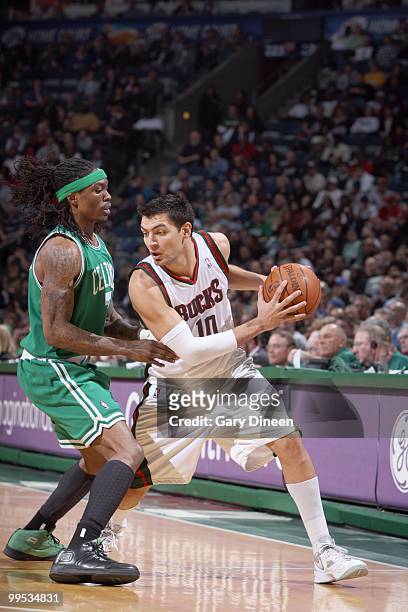 Carlos Delfino of the Milwaukee Bucks looks to move against Marquis Daniels of the Boston Celtics on March 9, 2010 at the Bradley Center in...