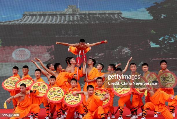 Performers take part in a martial arts performance at Shaolin Temple on Mount Songshan in Dengfeng County on July 7, 2018 in Zhengzhou, Henan...