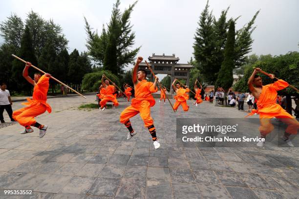 Performers take part in a martial arts performance at Shaolin Temple on Mount Songshan in Dengfeng County on July 7, 2018 in Zhengzhou, Henan...