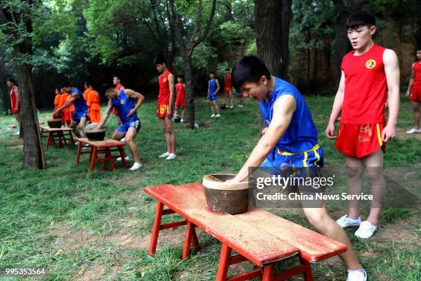 Performers take part in a martial arts performance at Shaolin Temple on Mount Songshan in Dengfeng County on July 7, 2018 in Zhengzhou, Henan...