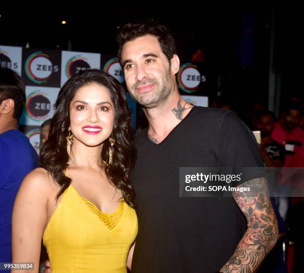 American-Canadian-Indian actress Sunny Leone with husband Daniel Weber pose for picture on the event where her Biopic 'Karenjit Kaur' launch in...