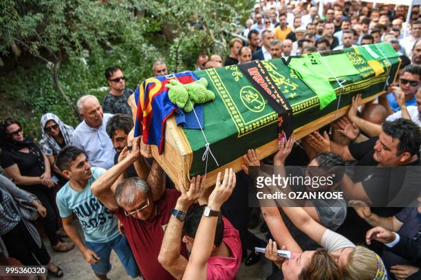 Mourners carry the coffin of Oguz Arda Sel victim of a train accident, during a funeral ceremony at Uzunkopru district in Edirne, on July 10, 2018. -...