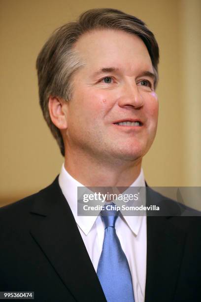 Judge Brett Kavanaugh poses for photographs before meeting with Senate Majority Leader Mitch McConnell in his office in the U.S. Capitol July 10,...