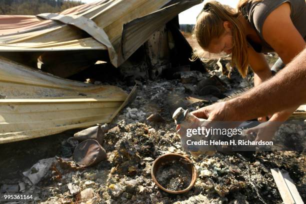 Larry Morgan finds a Christmas ornament while his daughter Tami Morgan carefully sifts through what used to be the front entrance of their family...