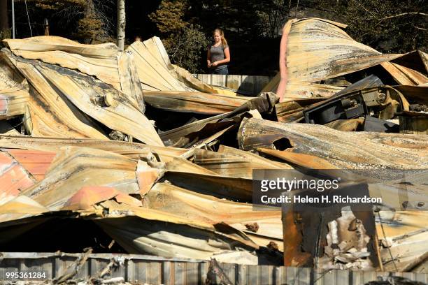 Tami Morgan looks at what remains of her family home at the bottom of La Veta pass on July 9, 2018 in La Veta, Colorado. The family lost their home...