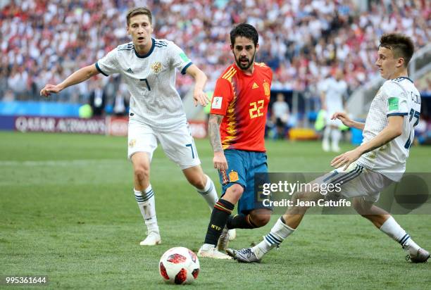 Isco of Spain between Daler Kuzyayev and Aleksandr Golovin of Russia during the 2018 FIFA World Cup Russia Round of 16 match between Spain and Russia...