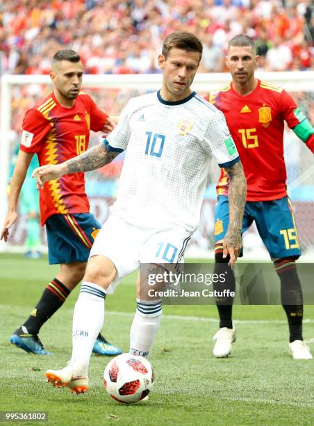 Fyodor Smolov of Russia between Jordi Alba and Sergio Ramos of Spain during the 2018 FIFA World Cup Russia Round of 16 match between Spain and Russia...