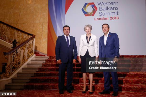 Zoran Zaev, Macedonia's prime minister, left, Theresa May, U.K. Prime minister, center, and Alexis Tsipras, Greece's prime minister, pose for a...