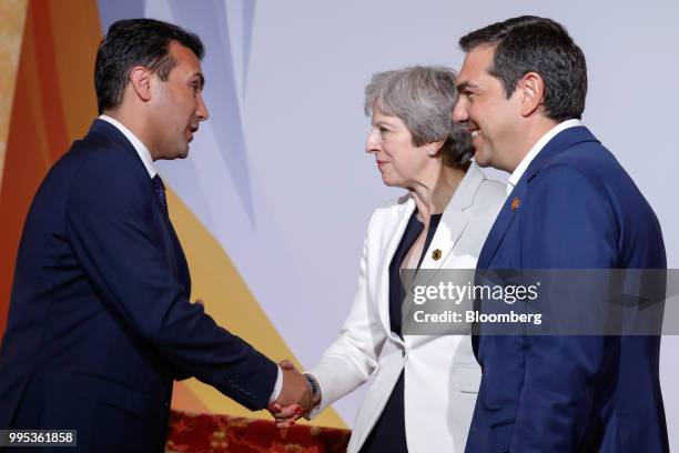 Zoran Zaev, Macedonia's Prime Minister, left, shakes hands with Theresa May, U.K. Prime minister, center, as Alexis Tsipras, Greece's prime minister,...