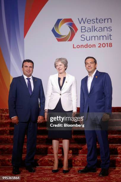 Zoran Zaev, Macedonia's prime minister, left, Theresa May, U.K. Prime minister, center, and Alexis Tsipras, Greece's prime minister, pose for a...