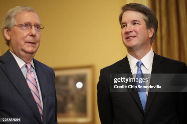 Senate Majority Leader Mitch McConnell and Judge Brett Kavanaugh pose for photographs before a meeting in McConnell's office in the U.S. Capitol July...