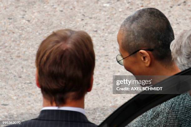 Liu Xia , the widow of Chinese Nobel Peace Prize laureate Liu Xiaobo, gets in to a car after she arrives at Tegel Airport in Berlin on July 10, 2018....