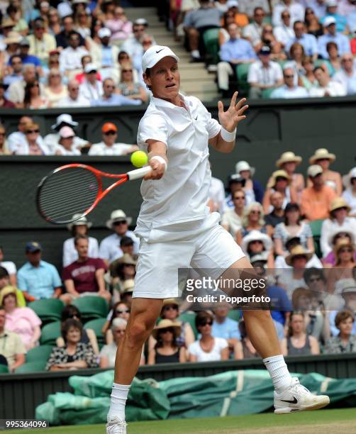 Tomas Berdych of the Czech Republic returns the ball against Roger Federer of Switzerland in the Mens Singles Quarter Final on day nine of the 2010...