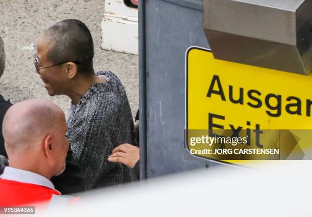 Liu Xia, the widow of Chinese Nobel Peace Prize laureate Liu Xiaobo, gets into a car after she arrives at Tegel Airport in Berlin on July 10, 2018. -...