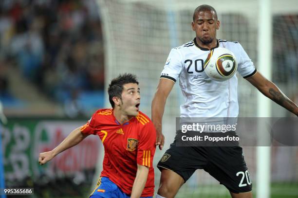 Jerome Boateng of Germany shields the ball from David Villa of Spain during the FIFA World Cup Semi Final at the Moses Mabhida Stadium on July 7,...