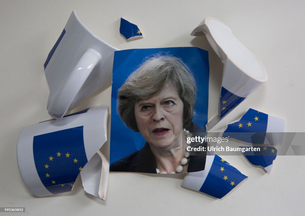 Brexit - portrait Theresa May and a broken coffee cup with the flag of  the European Union