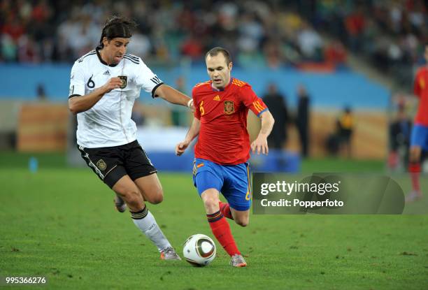 Andres Iniesta of Spain goes past Sami Khedira of Germany during the FIFA World Cup Semi Final at the Moses Mabhida Stadium on July 7, 2010 in...