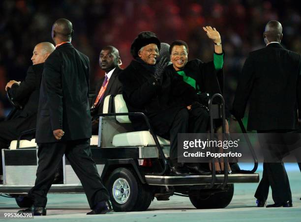 Former President of South Africa Nelson Mandela and his wife Graca Machel smile and wave to the crowd before the FIFA World Cup Final between the...