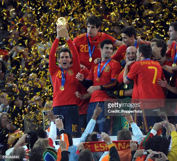 Cesc Fabregas of Spain lifts the trophy and celebrates with team-mates after the FIFA World Cup Final between the Netherlands and Spain on July 11,...