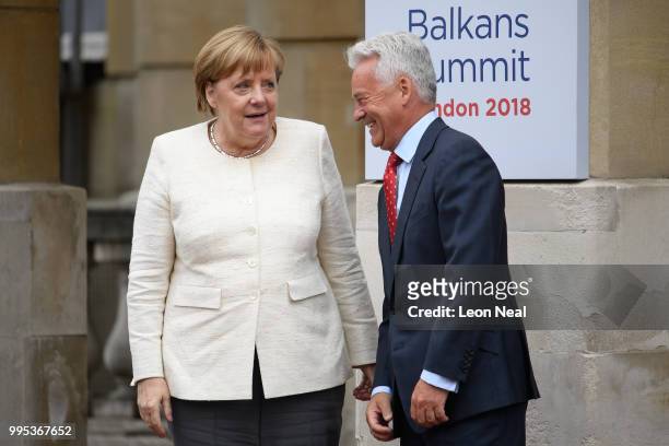 Germany's Chancellor Angela Merkel is greeted by Britain's Minister of State for Europe and the Americas Alan Duncan ahead of the Western Balkans...