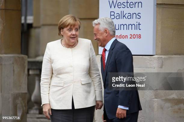 Germany's Chancellor Angela Merkel is greeted by Britain's Minister of State for Europe and the Americas Alan Duncan ahead of the Western Balkans...