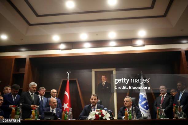 Berat Albayrak, Turkey's treasury and finance minister, center, speaks during a handover ceremony with Naci Agbal, outgoing Turkish finance minister,...