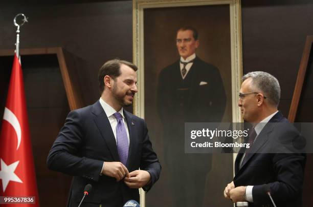 Berat Albayrak, Turkey's treasury and finance minister, left, speaks to Naci Agbal, outgoing Turkish finance minister, during a handover ceremony at...