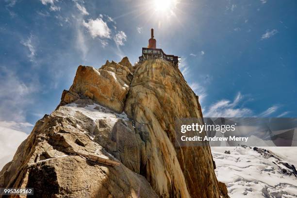 aiguille du midi summit, peak, rock formation back lit by the sun - aiguille de midi fotografías e imágenes de stock