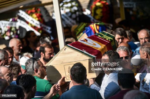 Mourners carry coffins of the victims of a train accident, Oguz Arda Sel and his father's, Hakan Sel during a funeral ceremony on July 10, 2018 at...