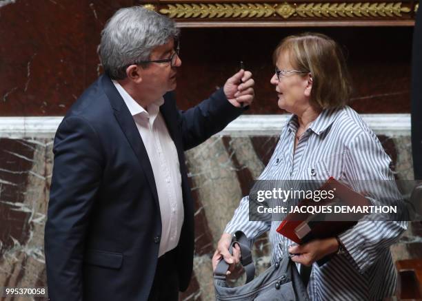 French communist deputy Marie-Georges Buffet speaks with far-right deputy Jean-Luc Melenchon at the end of a session of questions to the government...