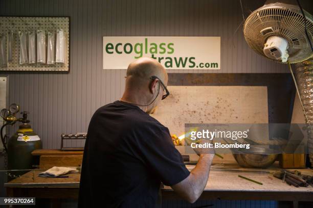 Worker uses a propane torch to polish a glass straw at the EcoGlass Straws manufacturing facility in Hood River, Oregon, U.S., on Thursday, July 5,...