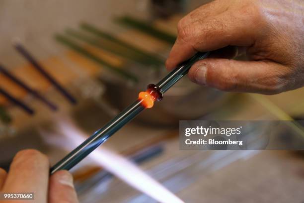 Worker uses a propane torch to add ridges to a glass straw at the EcoGlass Straws manufacturing facility in Hood River, Oregon, U.S., on Thursday,...