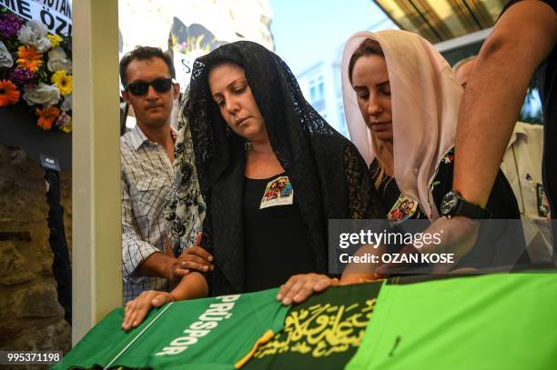 Misra Oz, mother of Oguz Arda Sel a victim of a train accident, mourns on his son's coffin along with the relatives, during a funeral ceremony at...