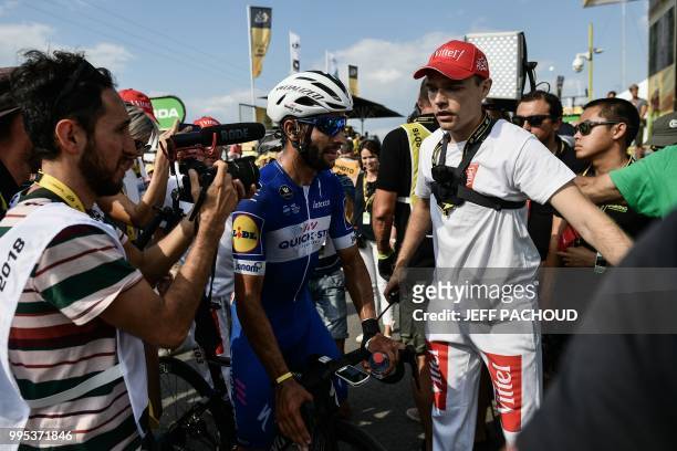 An official makes way for Colombia's Fernando Gaviria after he won the fourth stage of the 105th edition of the Tour de France cycling race between...