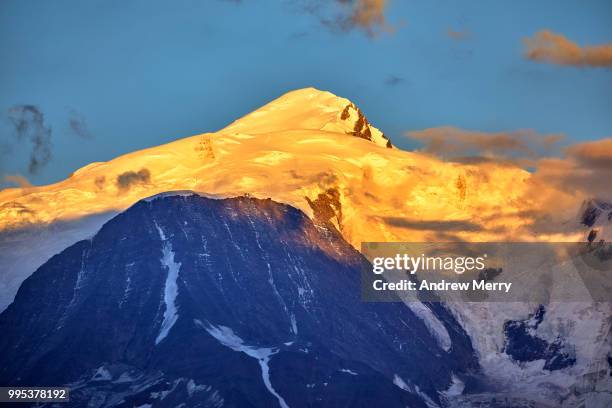 mont blanc summit, peak at sunset with blue sky and clouds - sallanches stockfoto's en -beelden