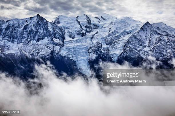 french alps mountain range with snow line. mont blanc summit, peak and glaciers with clouds in valley and overcast sky - pinnacle imagens e fotografias de stock