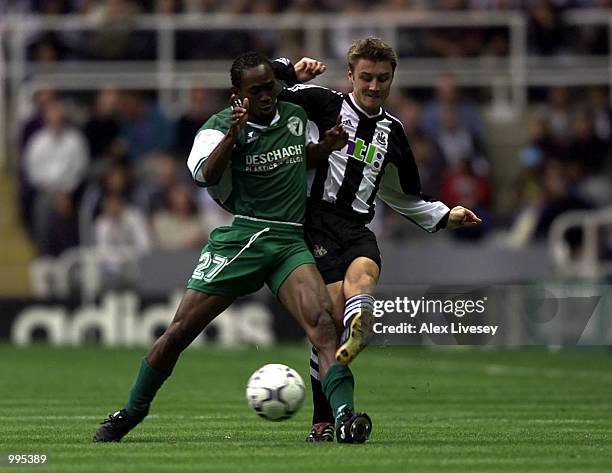 Patrick Zoundi of Lokeren holds off Wayne Quinn of Newcastle during the UEFA Intertoto third round second-leg match between Newcastle United and...