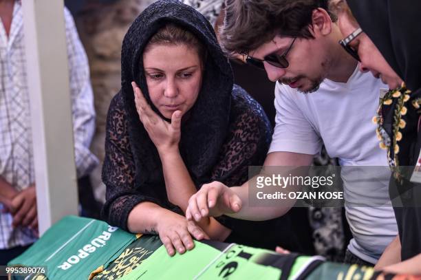 Misra Oz, mother of Oguz Arda Sel a victim of a train accident, mourns on his son's coffin along with the relatives, during a funeral ceremony at...