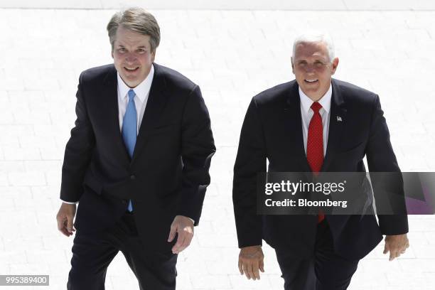 Brett Kavanaugh, U.S. Supreme Court associate justice nominee for U.S. President Donald Trump, left, and U.S. Vice President Mike Pence walk up the...