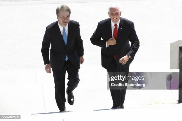 Brett Kavanaugh, U.S. Supreme Court associate justice nominee for U.S. President Donald Trump, left, and U.S. Vice President Mike Pence walk up the...