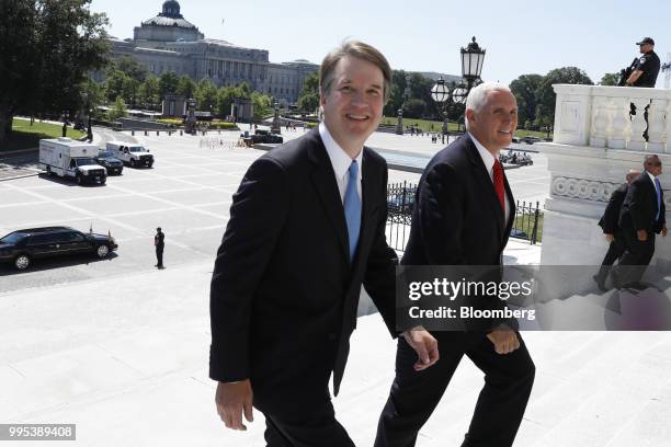 Brett Kavanaugh, U.S. Supreme Court associate justice nominee for U.S. President Donald Trump, left, and U.S. Vice President Mike Pence walk up the...