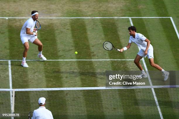 Robin Haase of the Netherlands and Robert Lindstedt of Sweden return a shot against Dominic Inglot of Great Britain and Franko Skugor of Croatia...