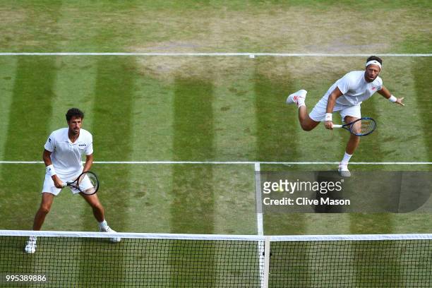 Robin Haase of the Netherlands and Robert Lindstedt of Sweden return a shot against Dominic Inglot of Great Britain and Franko Skugor of Croatia...
