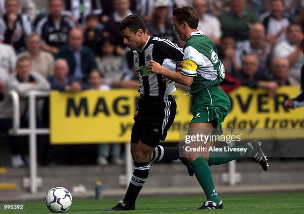 Christian Bassedas of Newcastle holds off Arnar Vidarsson of Lokeren during the UEFA Intertoto third round second-leg match between Newcastle United...